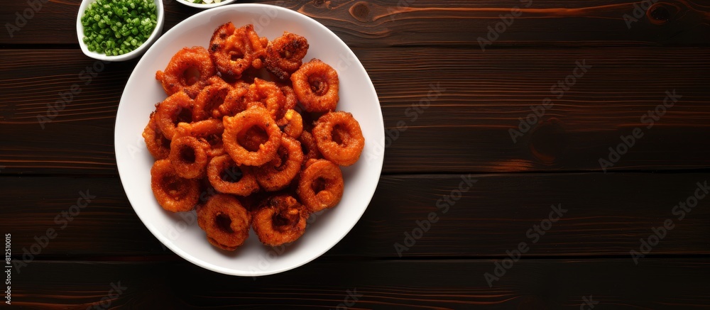 Poster Top view of bacon wrapped onion rings arranged in a white bowl on a brown background with plenty of empty space for other elements in the image. Creative banner. Copyspace image