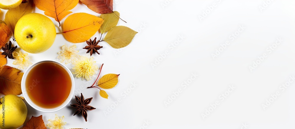 Poster Top view of a cup of tea adorned with lemon honey autumn leaves and apples placed on a white background This flat lay image captures the essence of autumn with ample copy space for any desired text
