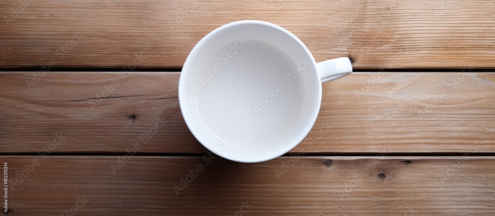 Aufkleber Top view of a white cup placed on a wooden surface showcasing an empty space in the image. Creative banner. Copyspace image