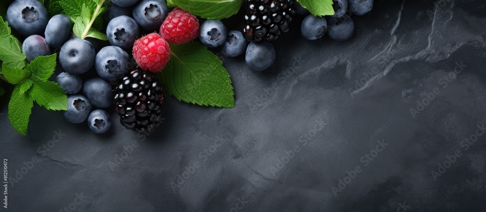 Poster Top view of a stone gray background showcasing a healthy and detoxifying concept with a visually appealing arrangement of berry fresh blueberries and fresh mint leaves on a black slate board Ample sp