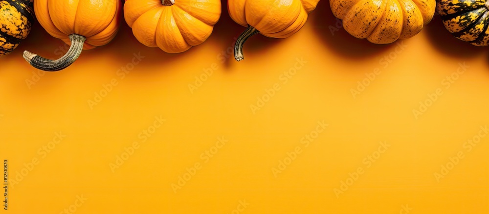 Aufkleber top view of pumpkins on a yellow background creating a festive autumn atmosphere this flat lay image