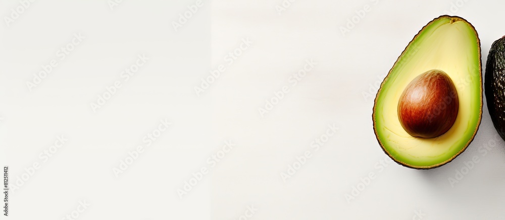 Poster A top view of a whole avocado on a light background with a frame that provides space for text. Creative banner. Copyspace image