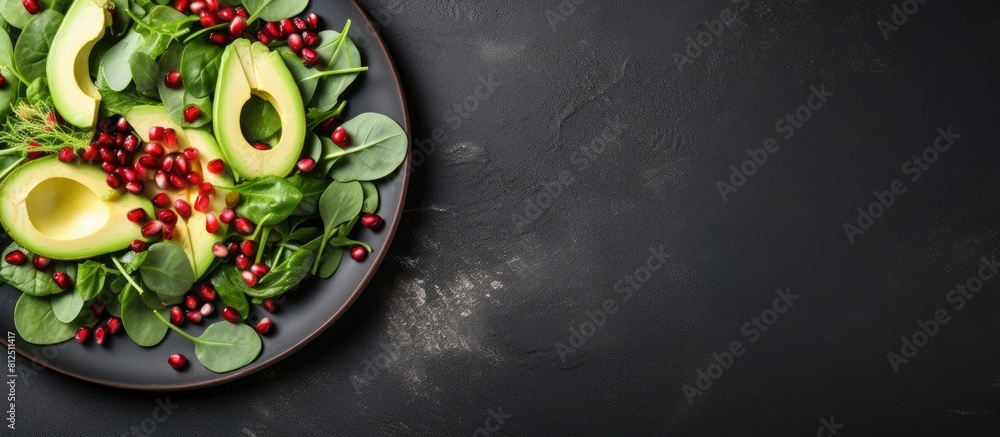Poster top view of a visually appealing avocado salad featuring baby spinach and pomegranate presented on a