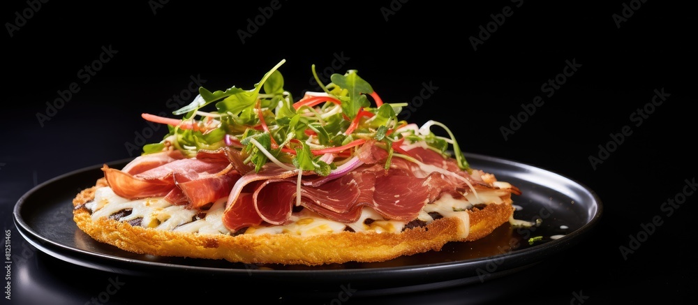 Poster a spanish tostada featuring delicious jamon iberico served on a plate with a copy space image