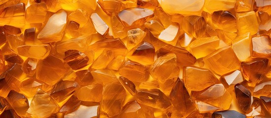 A vibrant amber wall adorned with numerous beautiful stones perfect for use as a texture or background in images requiring copy space