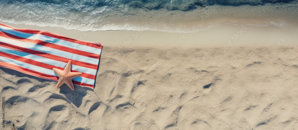 Poster top view of beach accessories and towel on a sandy beach with ample space for text a perfect image t