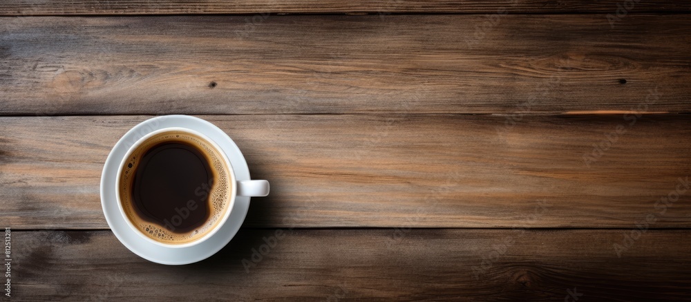 Poster a coffee cup viewed from above on a wooden table with a background for copy space image