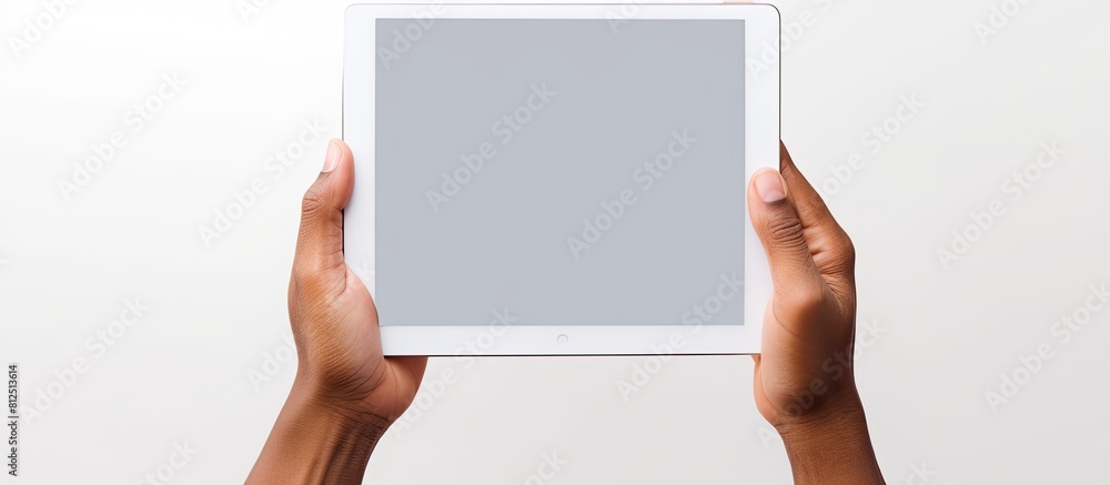 Poster A white background with a hand holding a tablet PC featuring a blank screen to insert an image. Creative banner. Copyspace image