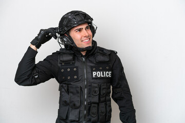 Fototapeta premium SWAT caucasian man isolated on white background having doubts and with confuse face expression