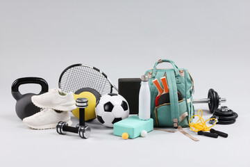 Many different sports equipment on light grey background