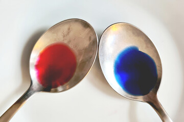 Two spoons with red and blue color