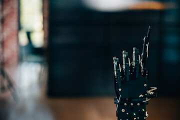 Black real robot hand illustrates futuristic design pressing on a table. Signifying artificial...