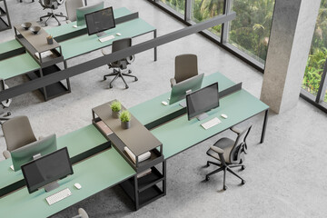 Top view of coworking interior with pc computers and armchairs near window