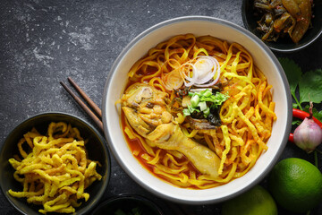 Thai food,Khao Soi Recipe,Khao Soi,Khao Soi Kai, Thai Noodles Khao Soi, Chicken Curry with seasoning on wooden floor, Northern Thai food concept. (Lanna food)