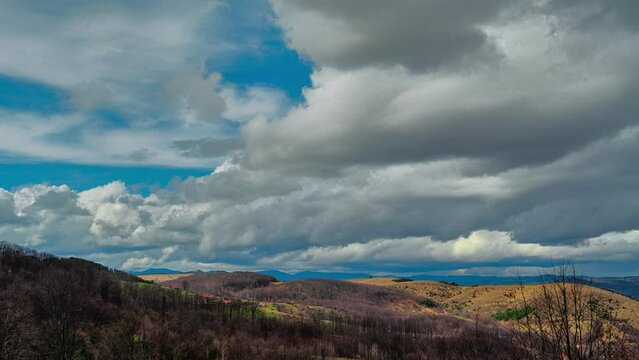 Nature landscape cumulus clouds rolling over hills and mountains time-lapse