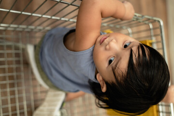 Little Child Sits In A Shopping Mall Grocery Cart