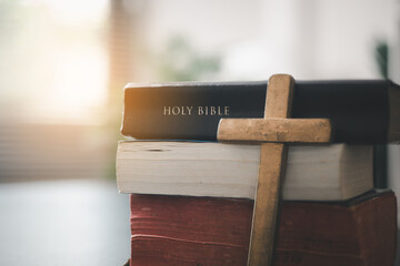 Holy Bible on the wooden table, Vintage church with the Bible against a black background, seekers...