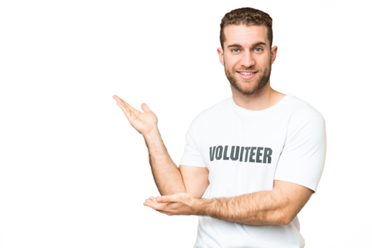 Young volunteer man over isolated chroma key background extending hands to the side for inviting to come