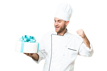 Young handsome blonde man with a big cake over isolated chroma key background celebrating a victory