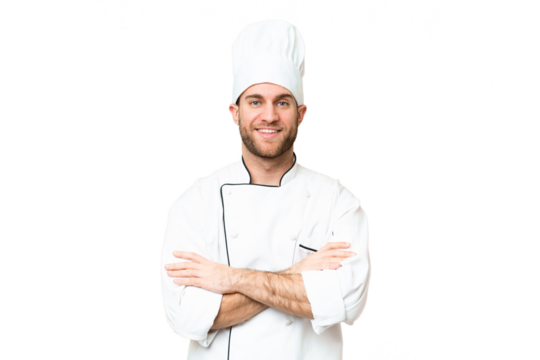 Young blonde man Chef over isolated chroma key background keeping the arms crossed in frontal position