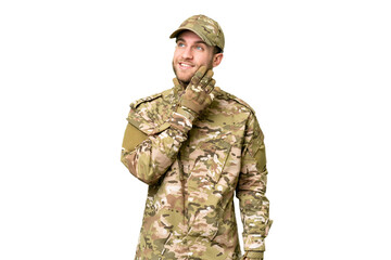 Military man over isolated chroma key background thinking an idea while looking up