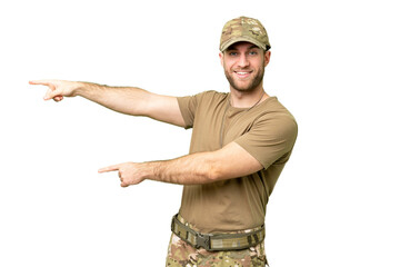 Military with dog tag over isolated chroma key background pointing finger to the side and...