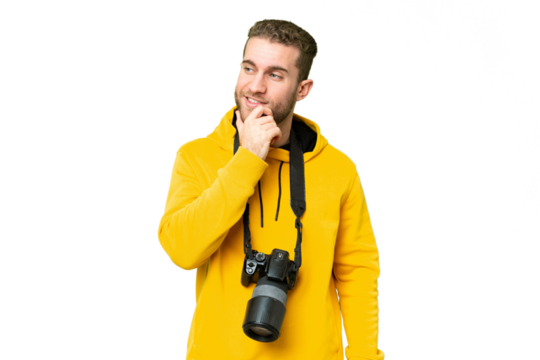 Young photographer man over isolated chroma key background looking to the side