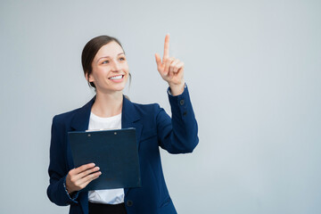 Happy young businesswoman presenting or pointing, happy working.