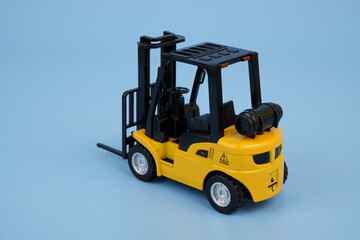 Yellow forklift truck on blue background