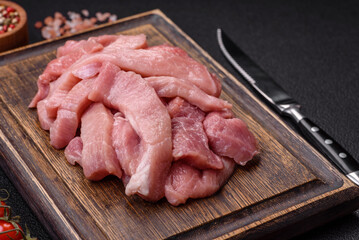 Slices of raw pork or turkey meat with salt, spices and herbs