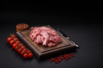 Slices of raw pork or turkey meat with salt, spices and herbs