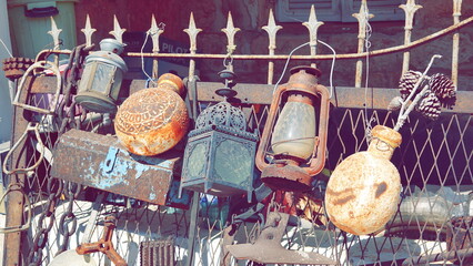Antique Utensils on the Wall on a sunny day outside. Beautiful vintage background. Garden...