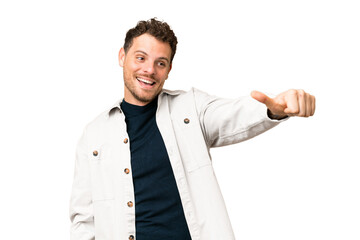 Brazilian man over isolated chroma key background giving a thumbs up gesture