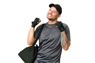 Young sport man with sport bag over isolated chroma key background making guitar gesture