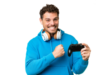 Brazilian man playing with a video game controller over isolated chroma key background celebrating a victory