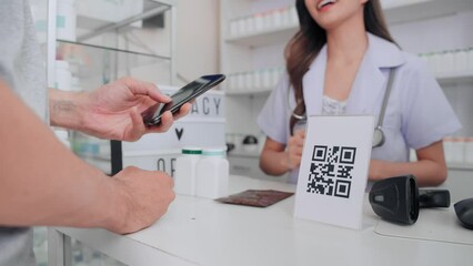 Professional Asian female pharmacist selling medicine and inform price to customer. Asian customer using smartphone for scanning QR code for paying at pharmacy. - Powered by Adobe
