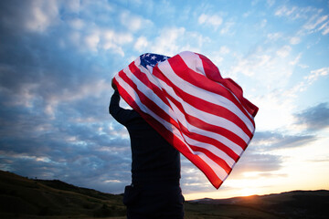 Man holding a waving american USA flag.