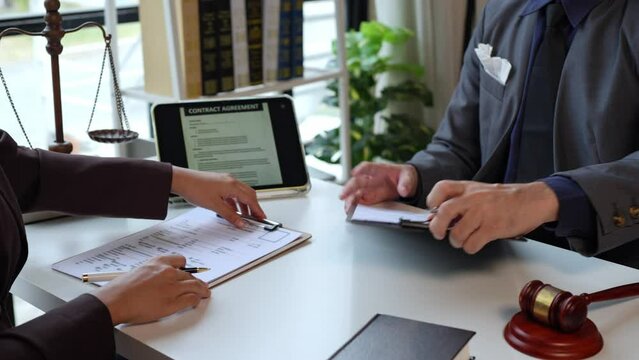 Lawyers provide legal advice and chat with clients via online tablets to clarify and give advice on the rules in contract documents that must be followed at the company correctly and fairly.