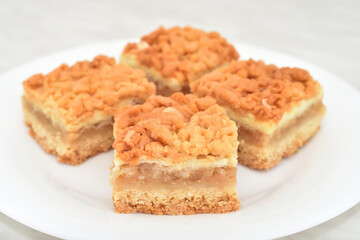 Pieces of homemade apple pie on the white plate. Close-up. Selective focus.
