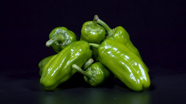 Close-up footage of green pepper on black background.