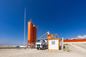 Concrete batching plant with a mixing tower and cement truck