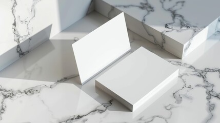 Two white business cards are displayed on a marble countertop