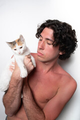 young athletic shirtless man with baby cat