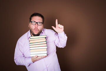 Tired and funny teacher with a lot of books. Brown background.