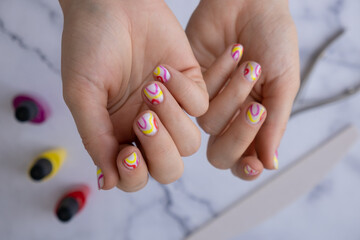 Pastel softness colorful manicured nails. Woman showing her new summer manicure in colors of pastel...