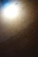 Background of the rammed earth wall with light bulb.