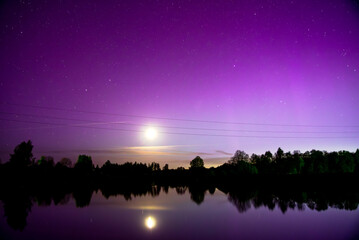 northern lights of the lake where you can see the reflection of the moon in the water