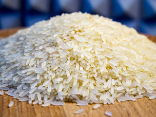 Pile of white rice on wood, clear focus, neutral mood, ideal for food preparation or nutrition...