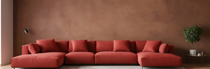 Red modular corner sofa against blank brown stucco wall with copy space. Loft interior design of modern living room design