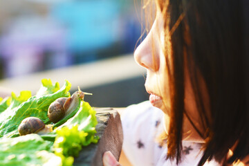 Latin schoolgirl looking at a snail.
